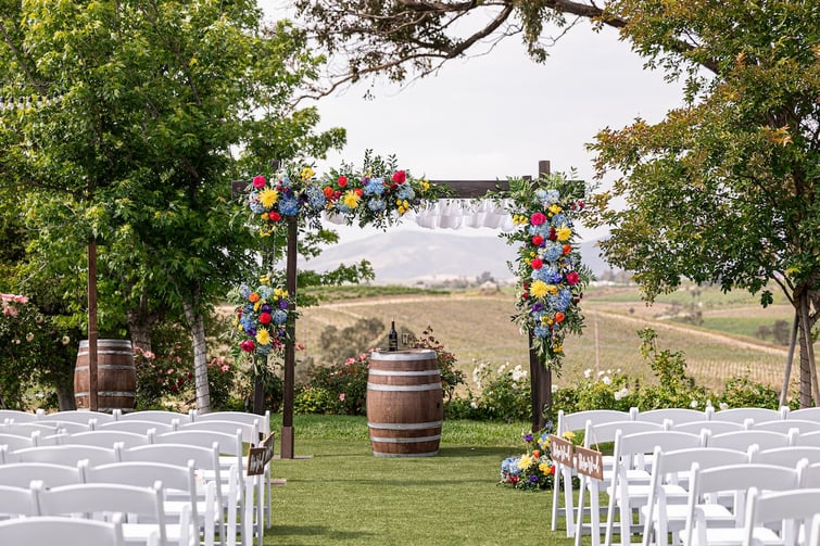 VIBRANT WEDDING CEREMONY WITH A COLORFUL ARRAY OF FLOWERS AT BEL VINO WINERY IN CALIFORNIA