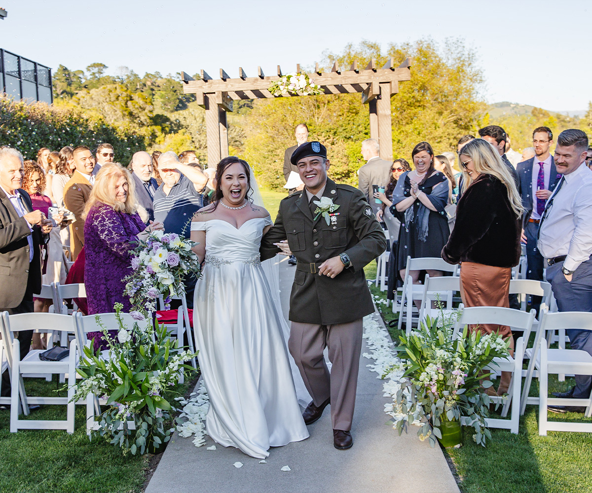 Bride and groom excited while walking down aisle- Carmel Fields by Wedgewood Weddings