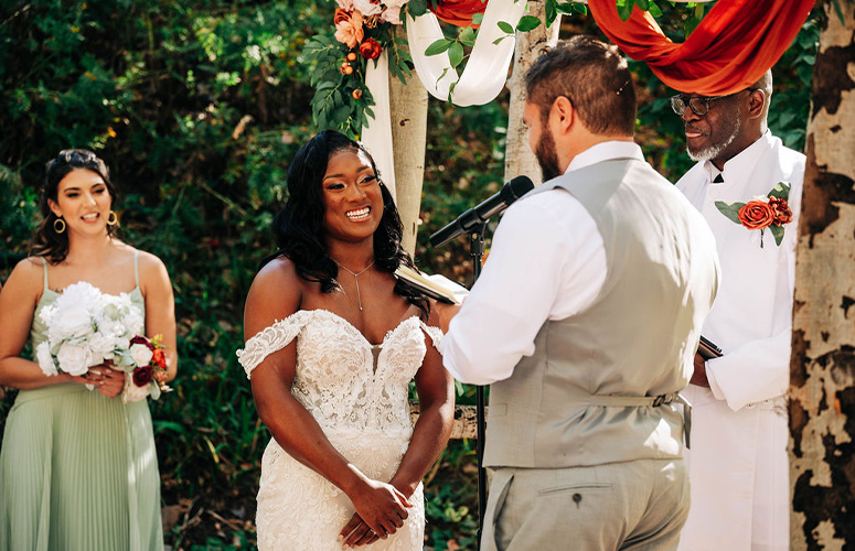 Bride smiling as groom reads his vows - Boulder Creek by Wedgewood Weddings