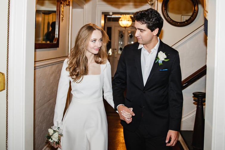 Couple holding hands inside Jefferson Street Mansion by Wedgewood Weddings