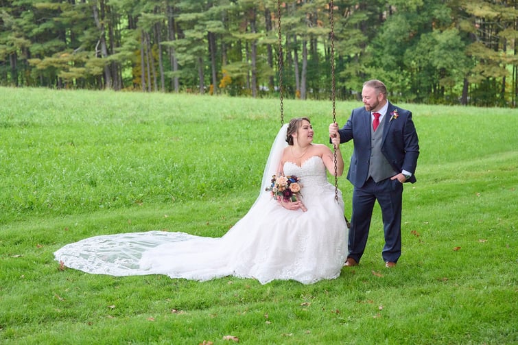 Couple on swing at Fern Hill Barn by Wedgewood Weddings