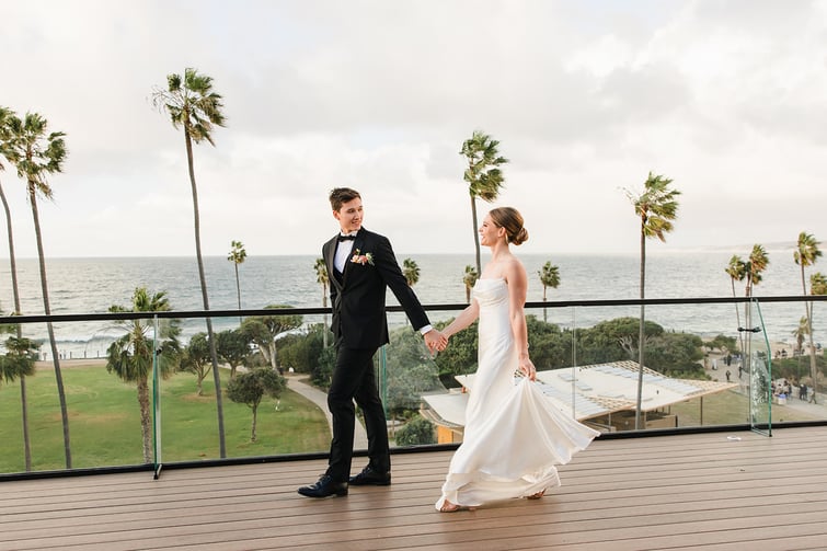 Couple walking together at La Jolla Cove Rooftop by Wedgewood Weddings