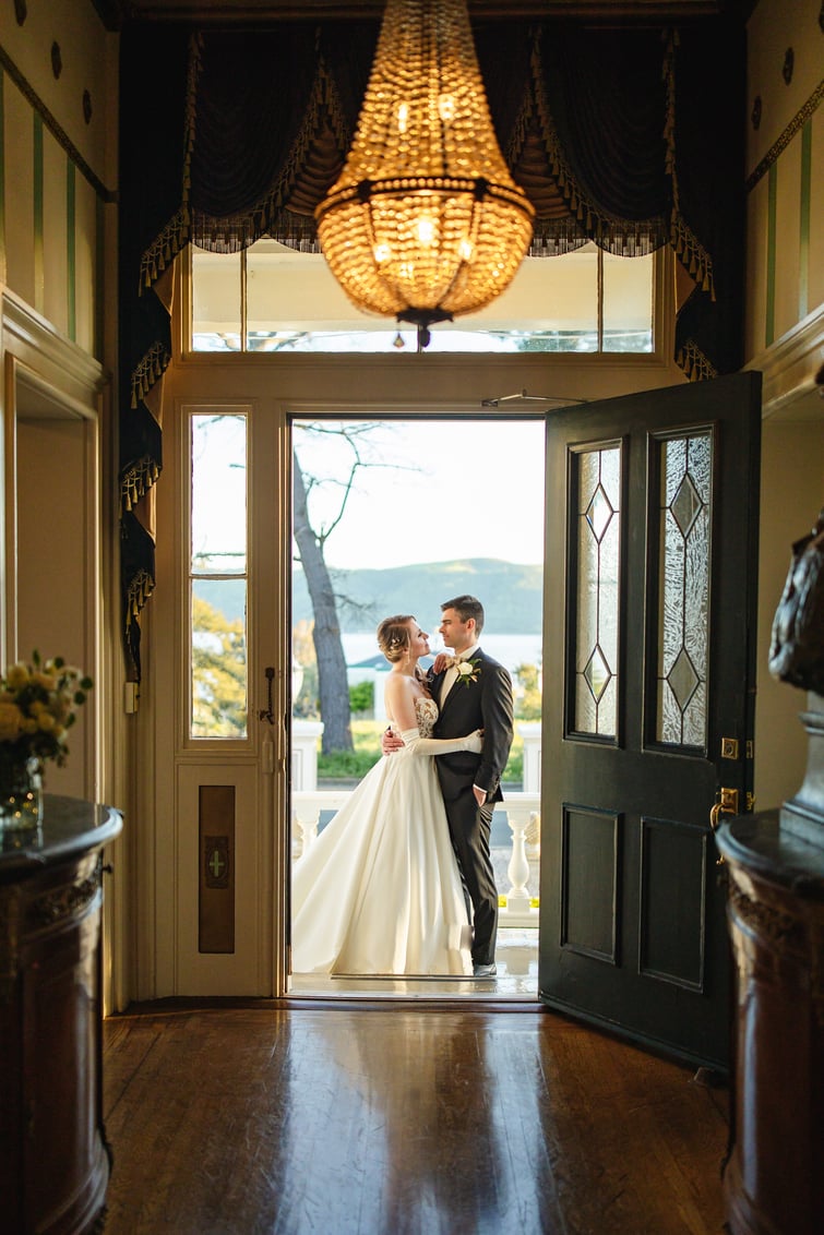 Couple with dramatic chandelier - Jefferson Street Mansion by Wedgewood Weddings