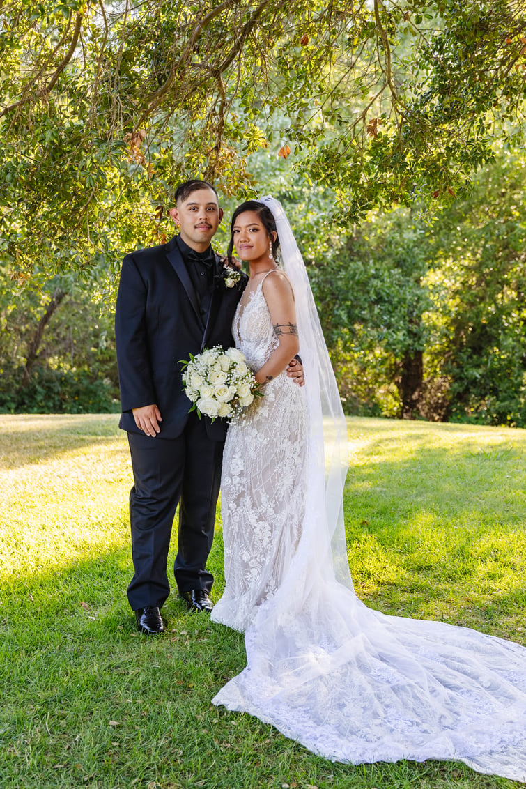 Newlyweds among greenery at Hiddenbrooke Hills by Wedgewood Weddings