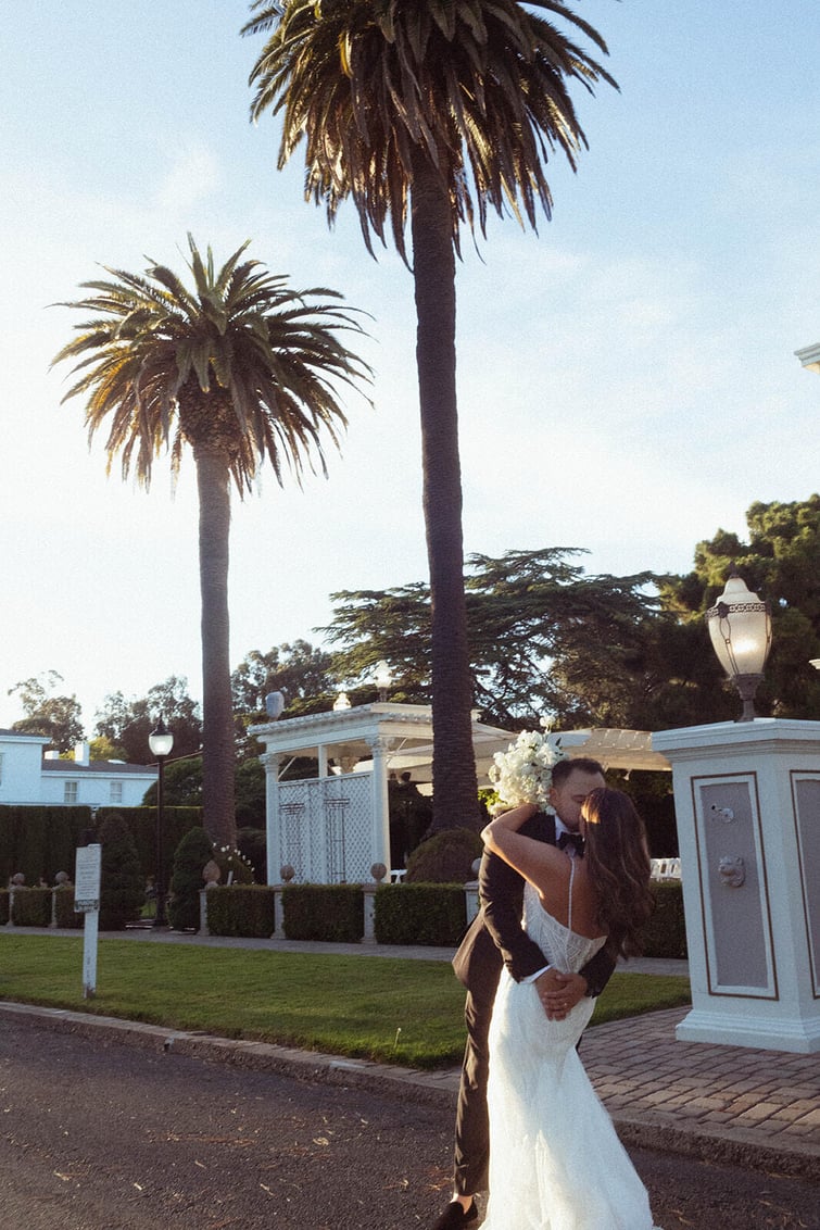 Newlyweds kissing outside - Jefferson Street Mansion by Wedgewood Weddings