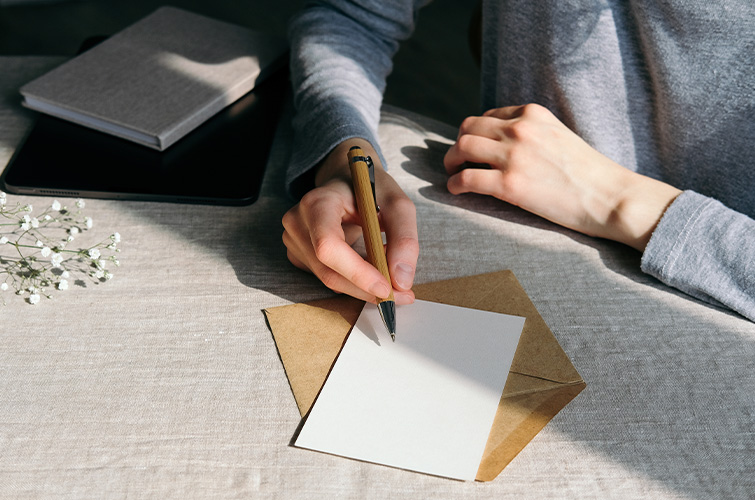 Person filling out a wedding card