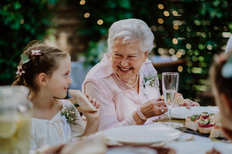 family members and guests smiling and eating