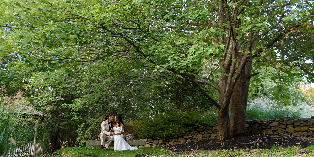 Couple among lush greenery at Granite Rose by Wedgewood Weddings