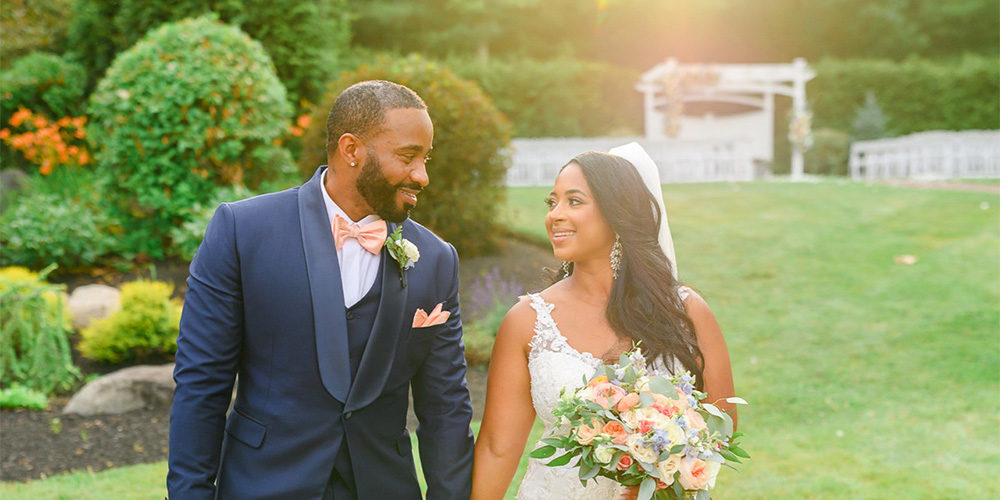 Couple holding hands at Miraval Gardens by Wedgewood Weddings near Boston