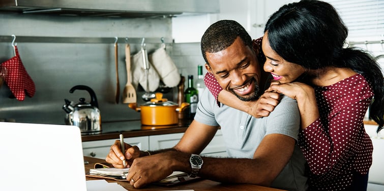 Couple hugging and planning in the kitchen