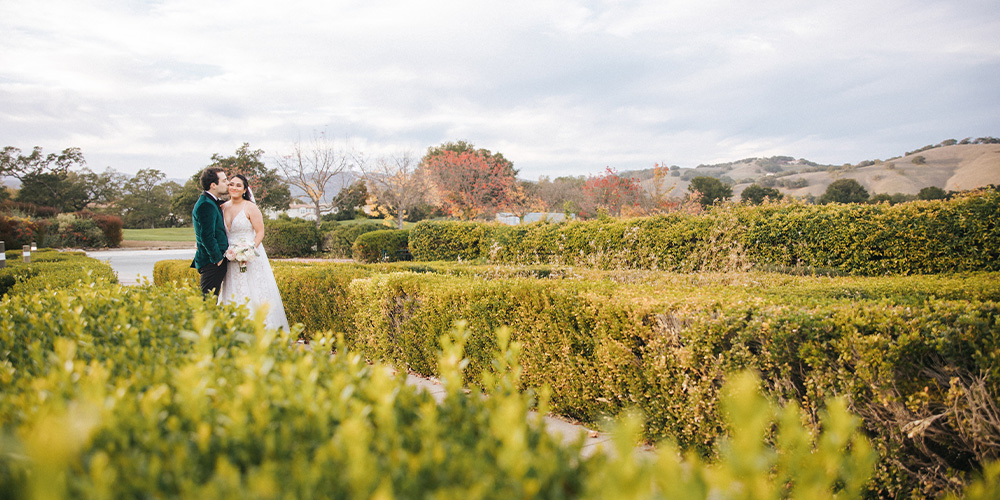 Couple in hedges at Eagle Ridge by Wedgewood Weddings