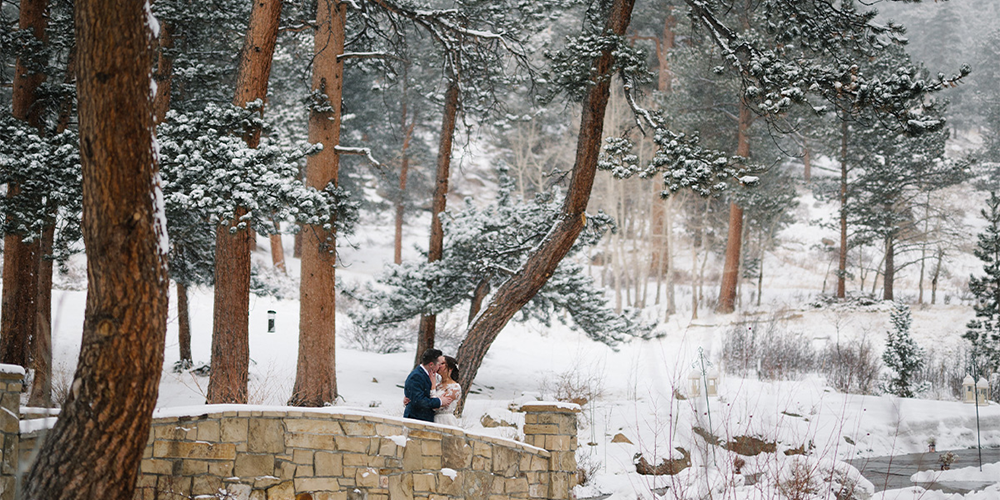 Couple on snowy bridge at Della Terra by Wedgewood Weddings