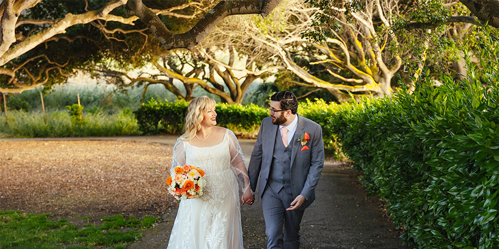 Couple walking through gorgeous trees at Carmel Fields by Wedgewood Weddings