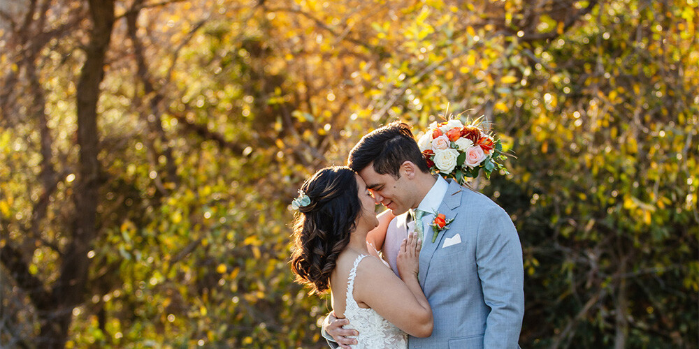 Couple among gorgeous fall foliage at Hiddenbrooke Hills by Wedgewood Weddings