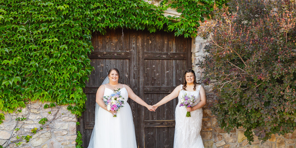 Lovely brides in front of wooden doors at Winchester Estate by Wedgewood Weddings