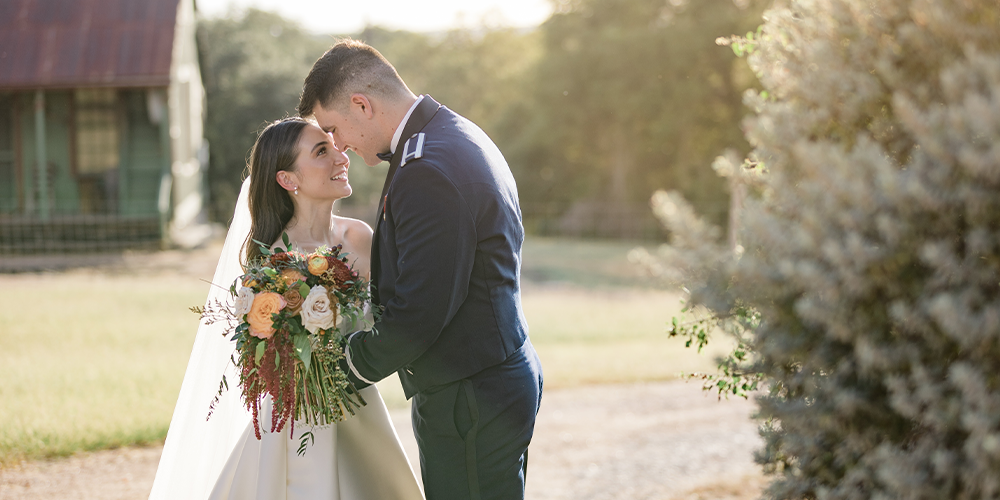 Newlyweds in front of rustic barn at Scenic Springs by Wedgewood Weddings