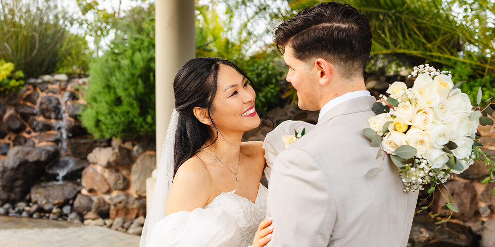 Newlyweds in front of greenery at Union Brick by Wedgewood Weddings