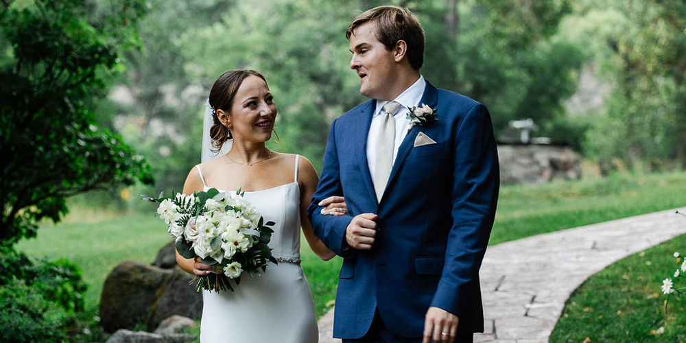 Couple walking next to Boulder Creek at Boulder Creek by Wedgewood Weddings