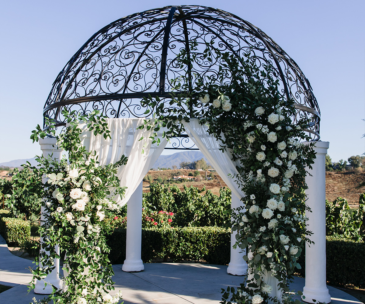 Stunning floral decorating the ceremony arch at Avensole Winery