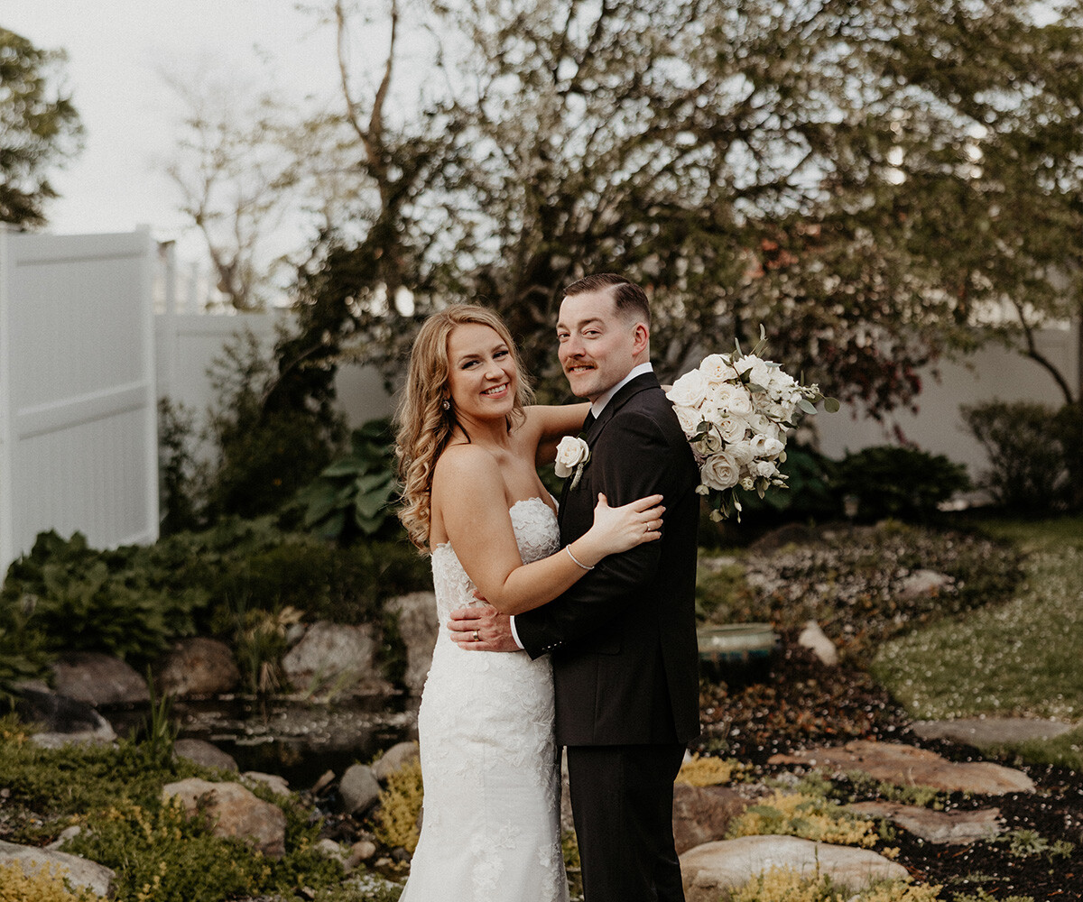 Happy couple among greenery at Barker House by Wedgewood Weddings