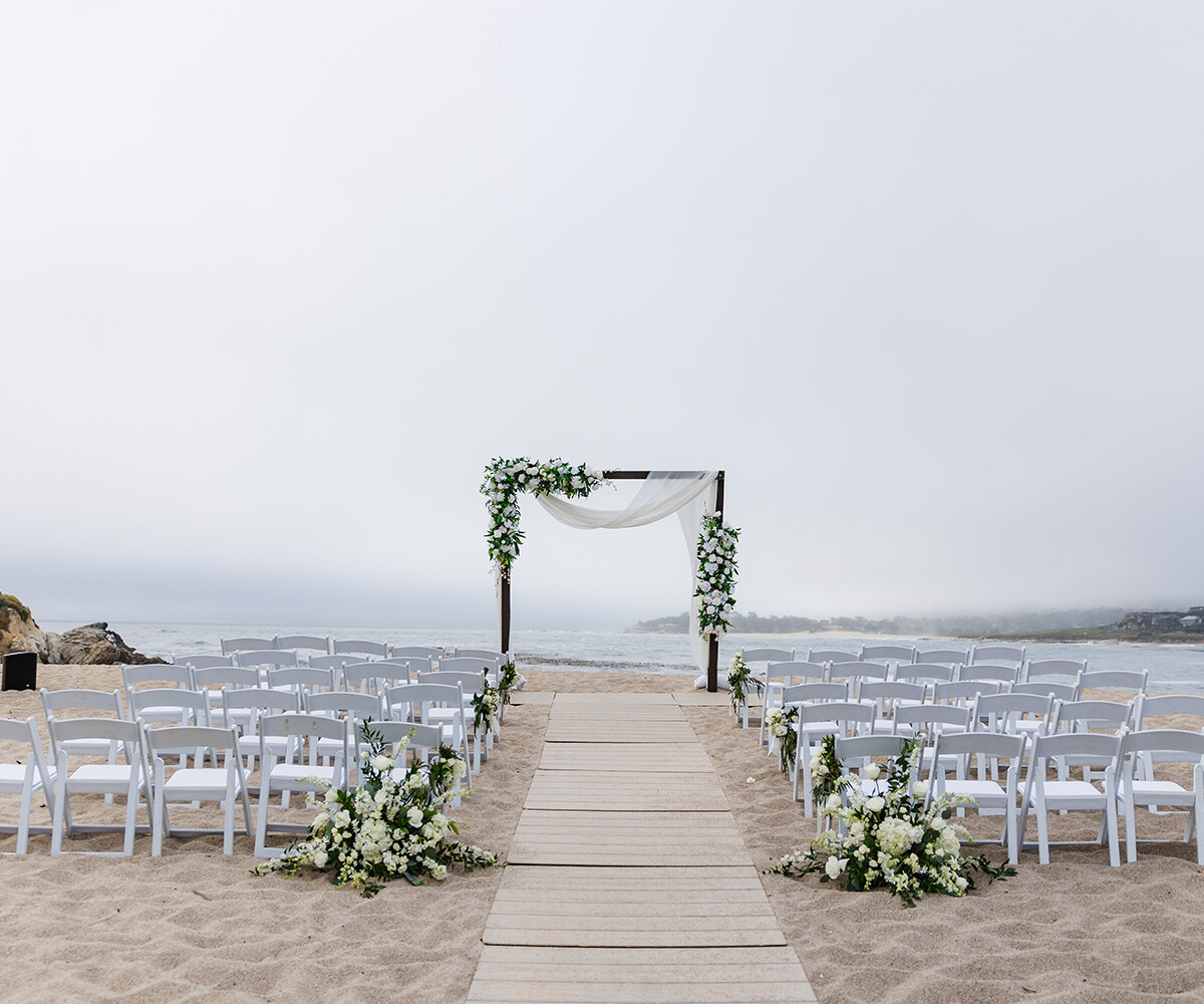 Beach ceremony with beautiful florals - Carmel Fields by Wedgewood Weddings