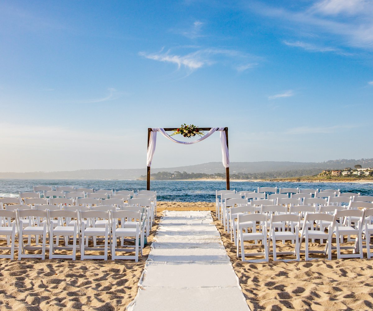 Beach ceremony with dark wood arbor and white aisle runner - Carmel Fields by Wedgewood Weddings