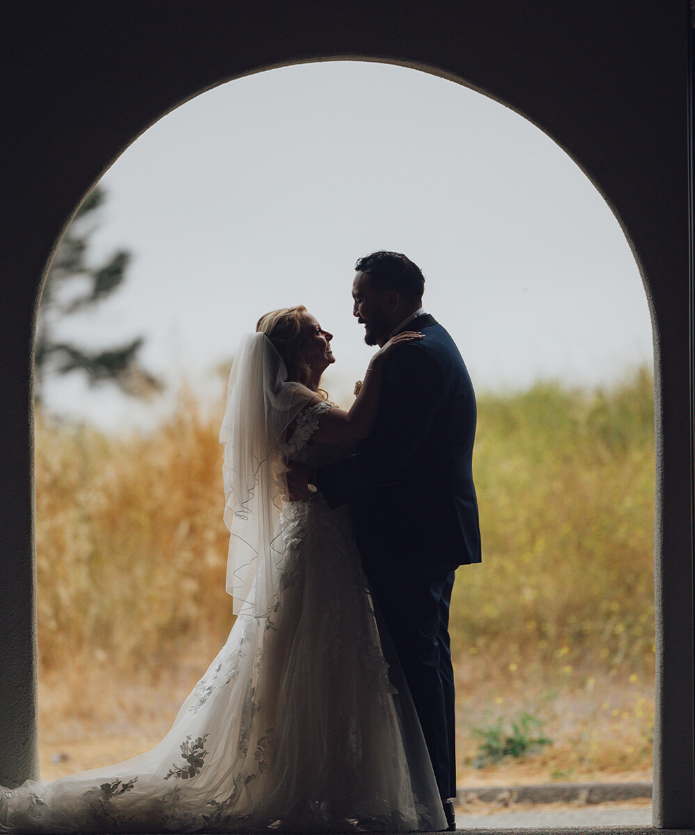 Couple hugging in doorway - Carmel Fields by Wedgewood Weddings