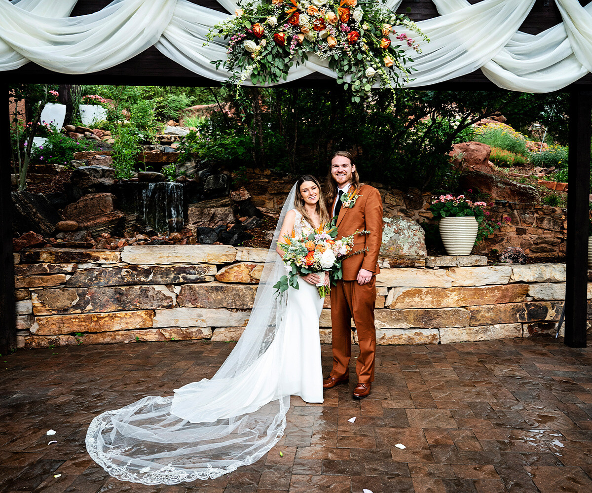 Couple in front of arch - Craftwood Peak by Wedgewood Weddings