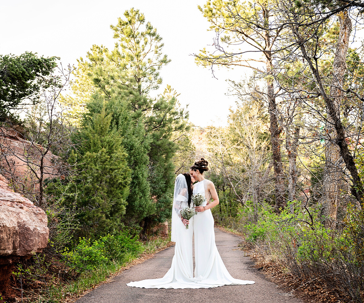 Couple kissing among trees and greenery - Craftwood Peak by Wedgewood Weddings