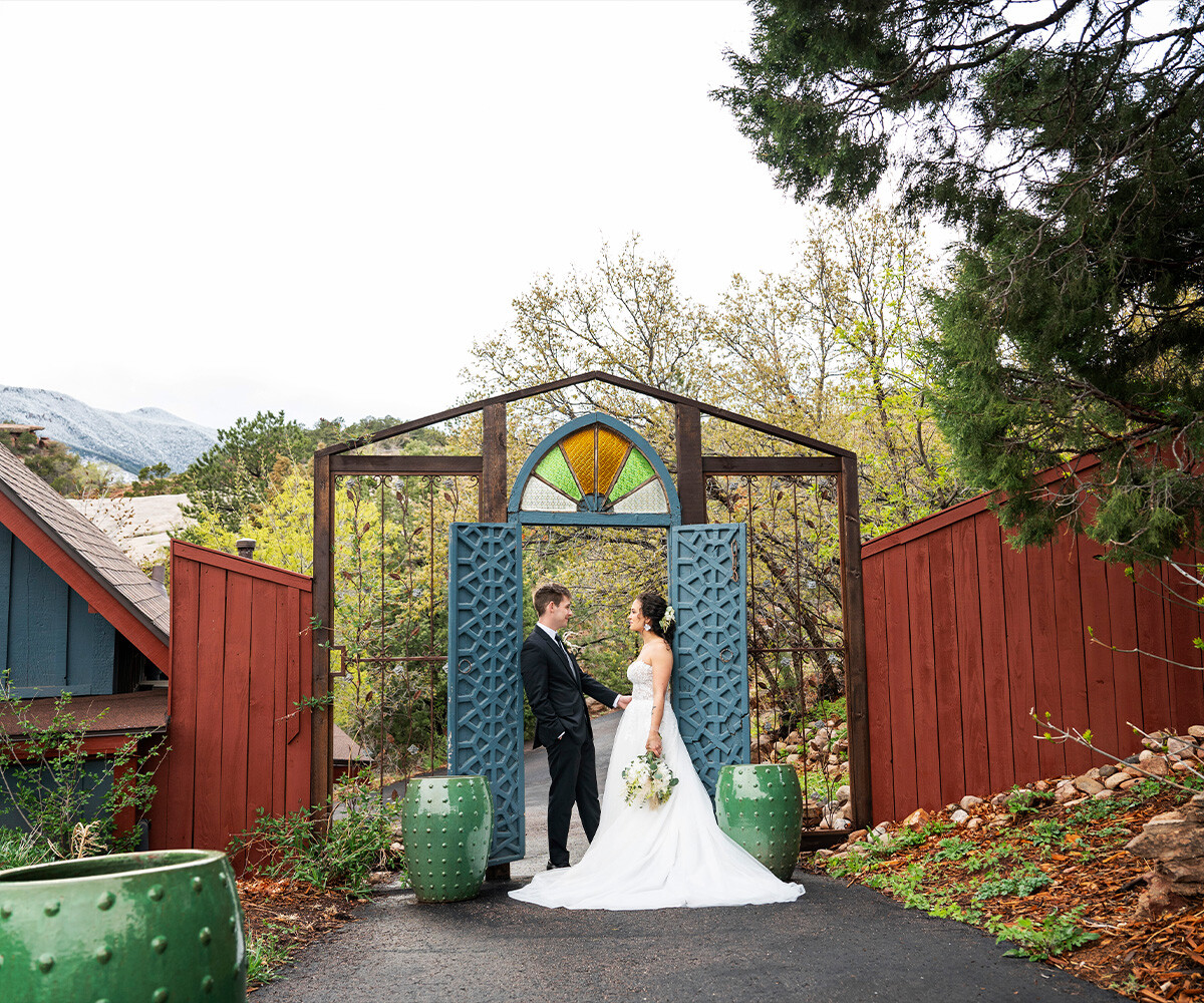 Couple posing in front of charming doors - Craftwood Peak by Wedgewood Weddings