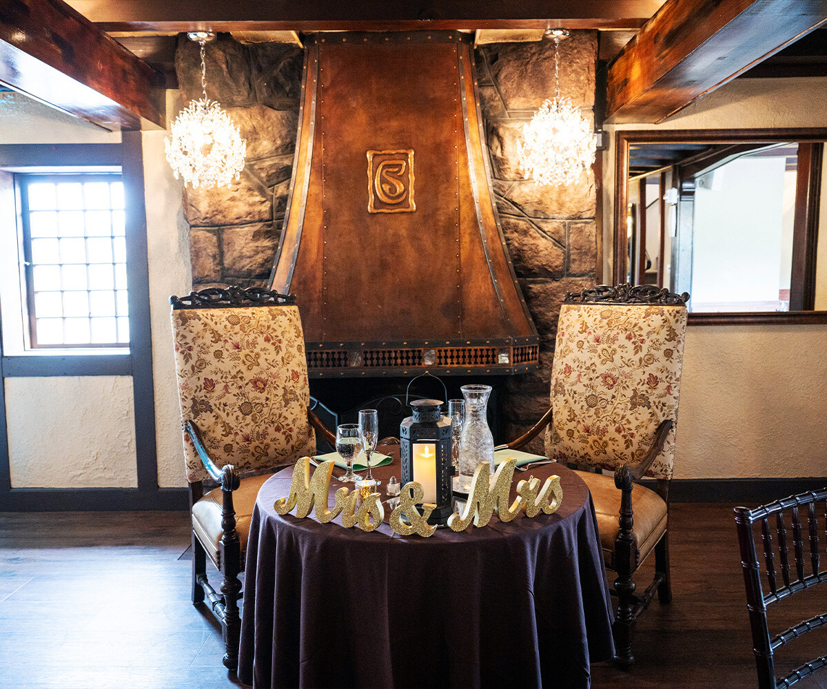 Sweetheart table by fireplace - Craftwood Peak by Wedgewood Weddings