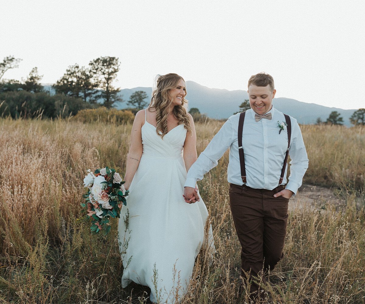 Couple walking through meadow - Creekside Terrace by Wedgewood Weddings