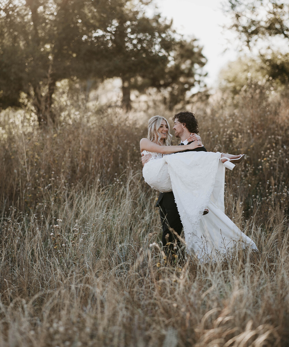 Newlyweds in meadow - Creekside Terrace by Wedgewood Weddings