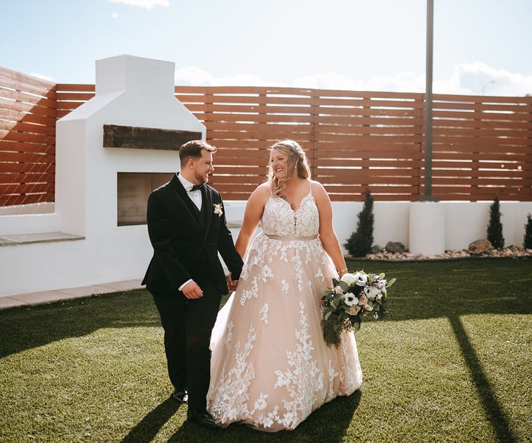 Newlyweds walking by fireplace - Creekside Terrace by Wedgewood Weddings