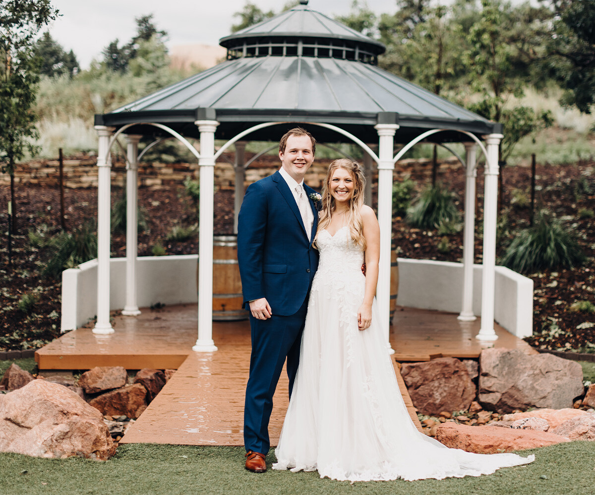 Wedding couple on rainy day in front of gazebo - Creekside Terrace by Wedgewood Weddings