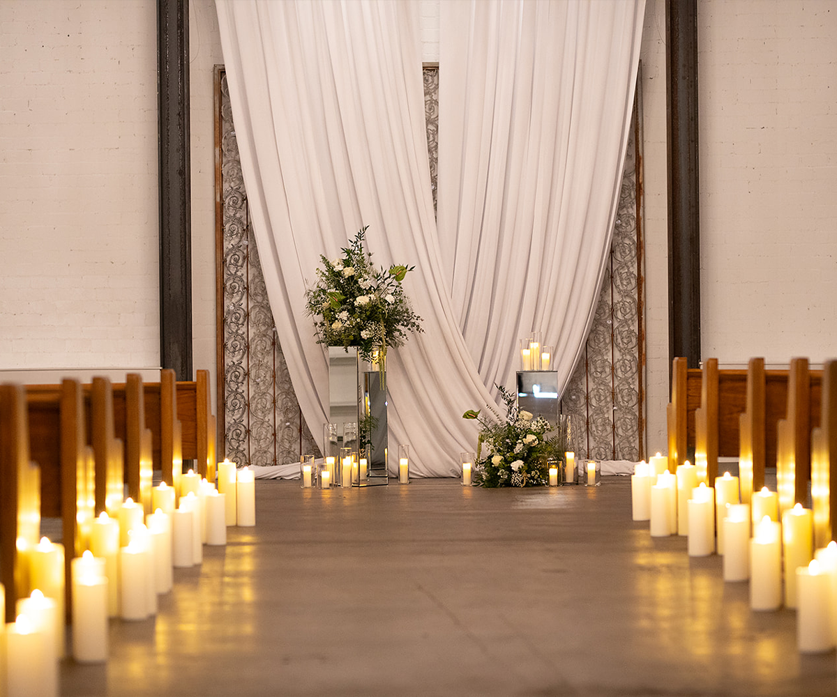 Romantic indoor ceremony with candles at Croft Downtown by Wedgewood Weddings