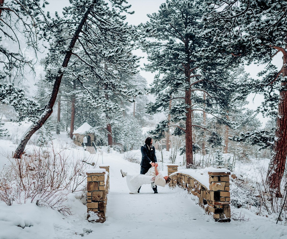 Couple on bridge in the snow - Della Terra by Wedgewood Weddings