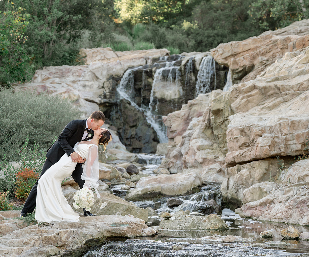Bride and Groom kissing by the Dove Canyon waterfall