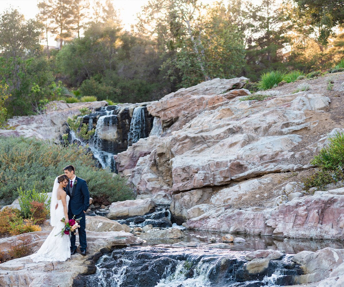 Couple in front of gorgeous waterfall - Dove Canyon by Wedgewood Weddings