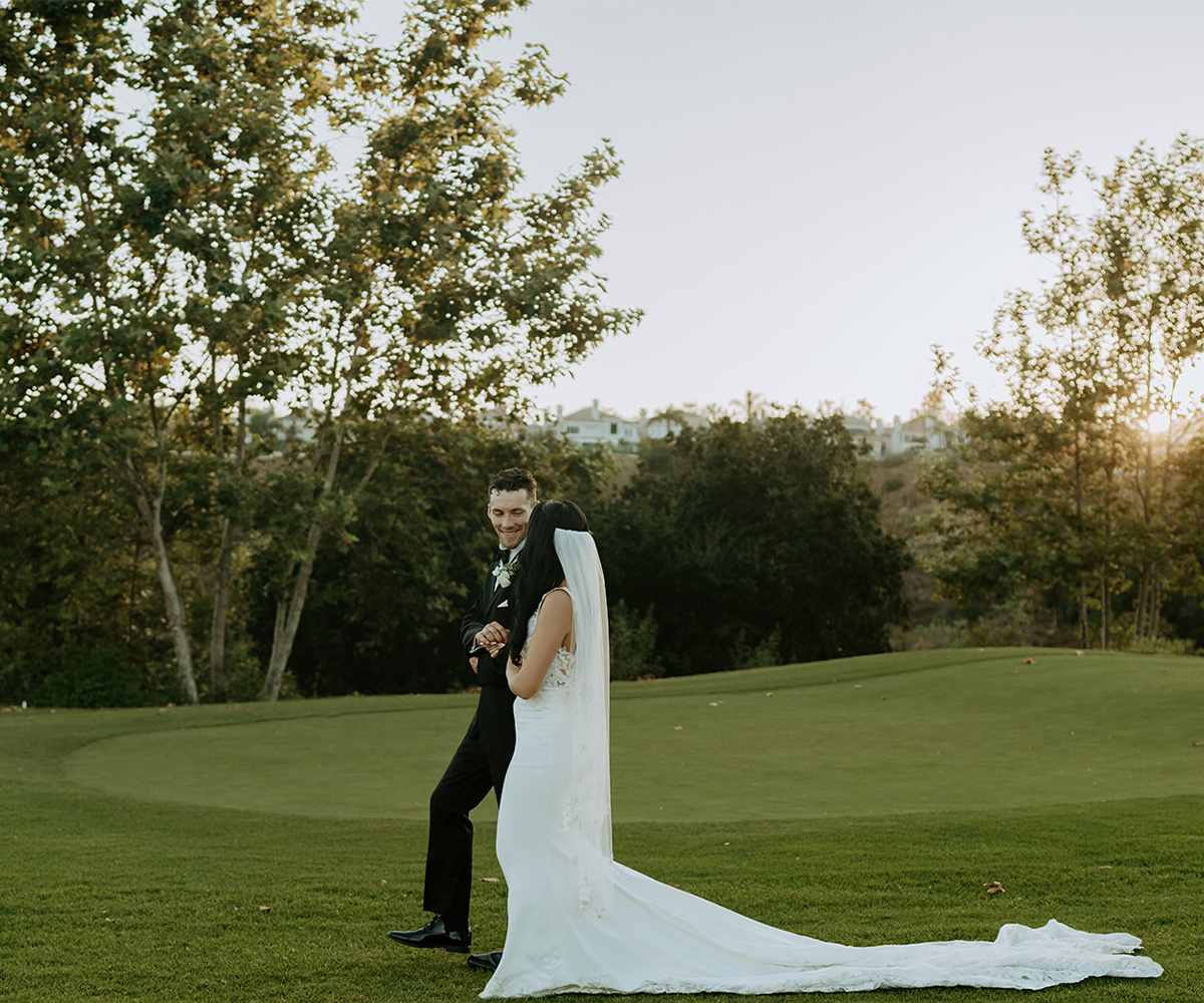 Couple standing together on the golf course at Dove Canyon by Wedgewood Weddings