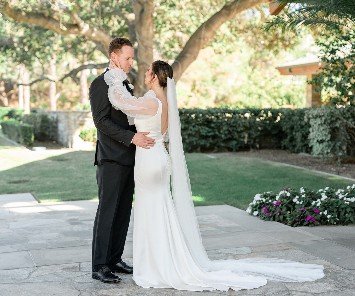 Just married couple embracing on the stone patio at Dove Canyon