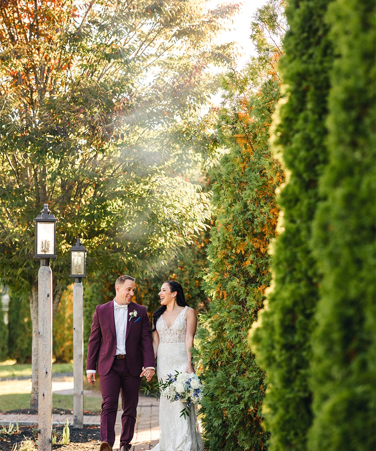 Couple walking through stunning grounds at Groveland Fairways by Wedgewood Weddings