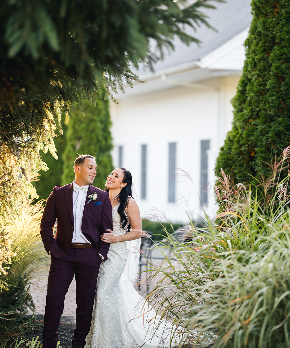 Newlyweds among greenery at Groveland Fairways by Wedgewood Weddings