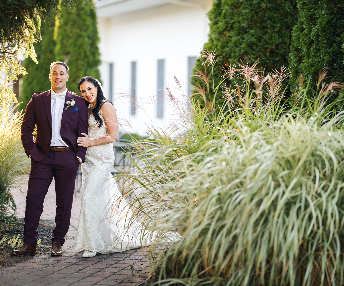 Newlyweds among lush greenery at Groveland Fairways by Wedgewood Weddings