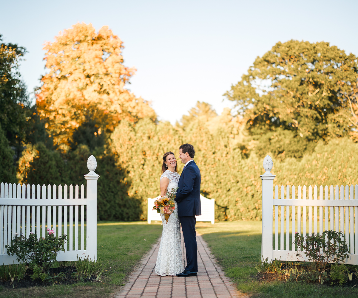 Newlyweds embracing in garden at Groveland Fairways by Wedgewood Weddings