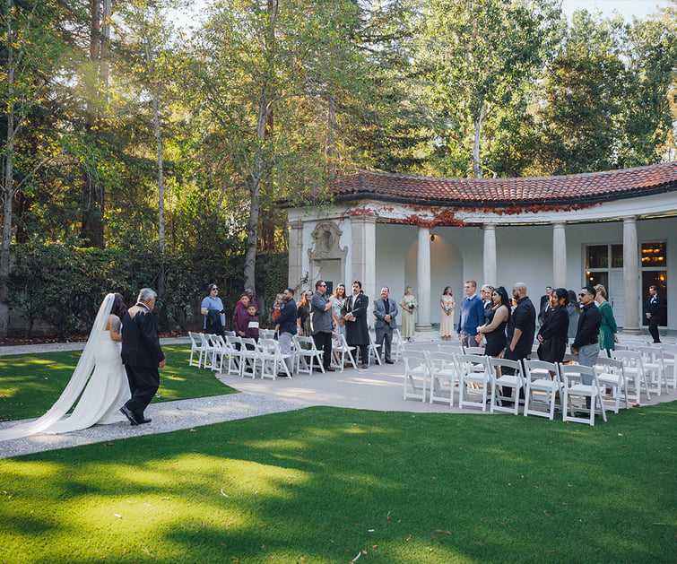 Bride walking down aisle at columns ceremony - Hacienda de las Flores by Wedgewood Weddings