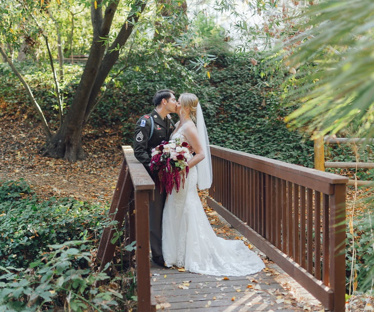 Couple kissing on bridge - Hacienda de las Flores