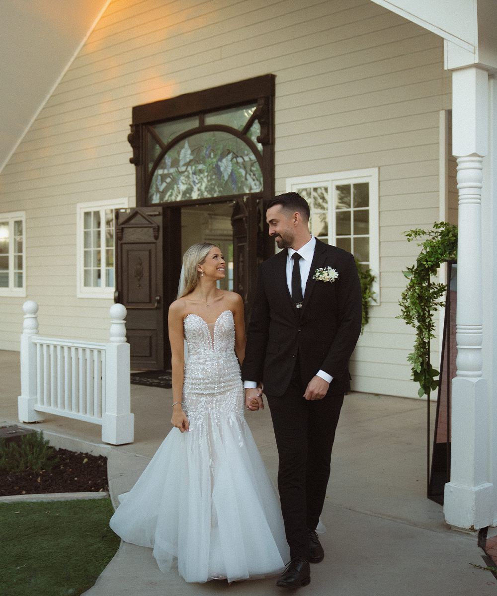 Couple walking in front of doors at Lindsay Grove by Wedgewood Weddings