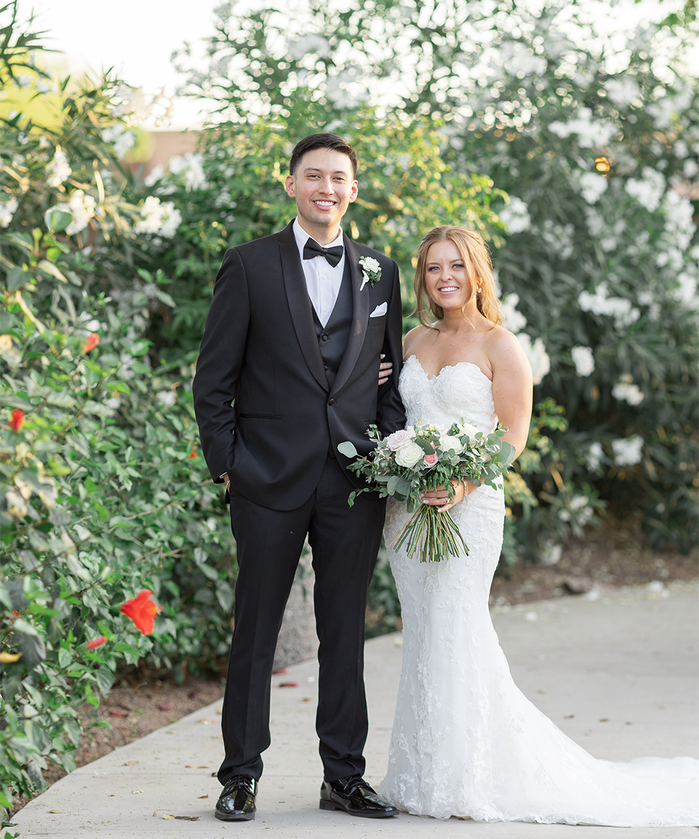 Newlyweds in front of greenery - Lindsay Grove by Wedgewood Weddings