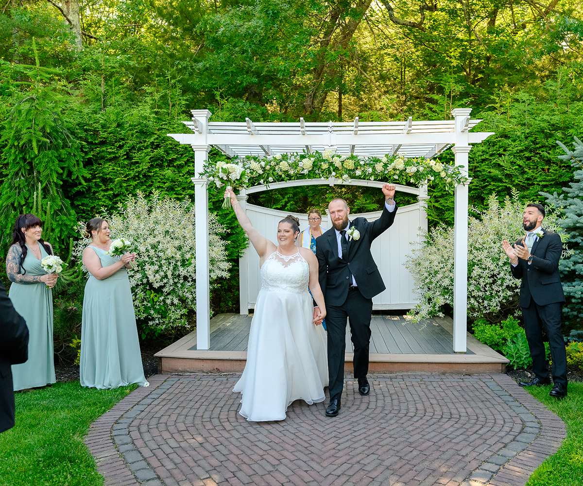 Couple walking down the aisle at Miraval Gardens by Wedgewood Weddings